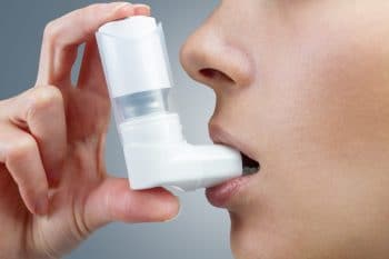 Someone using asthma puffer